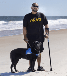David and Service Dog Kellen standing at the beach